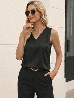Lifestyle front view of the black satin v-neck sleeveless blouse, showing its silhouette and design details.