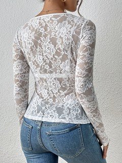 Angled back view of the white scalloped v-neck lace top, showing its silhouette and design details.