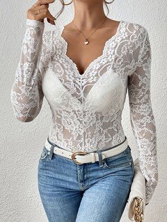Front view of the white scalloped v-neck lace top, showing its silhouette and design details.