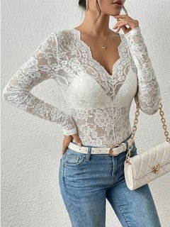Lifestyle front view of the white scalloped v-neck lace top, showing its silhouette and design details.