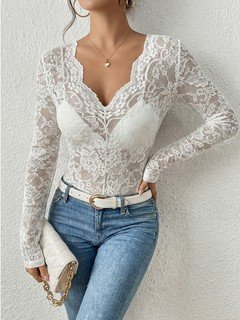 Styled front view of the white scalloped v-neck lace top, showing its silhouette and design details.