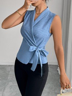 Alternate front view of the blue sleeveless side-tie wrap top, showing its silhouette and design details.