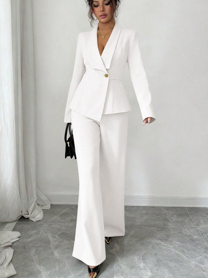 Angled front view of the ivory shawl-collar blazer pants set, showing its silhouette and design details.