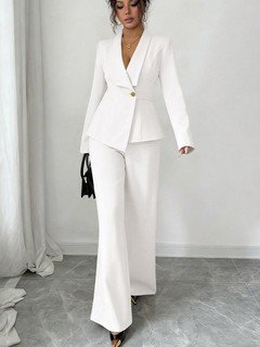 Angled front view of the ivory shawl-collar blazer pants set, showing its silhouette and design details.