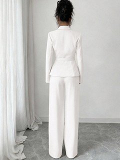 Back view of the ivory shawl-collar blazer pants set, showing its silhouette and design details.