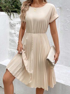 Angled front view of the cream short-sleeve pleated midi dress, showing its silhouette and design details.