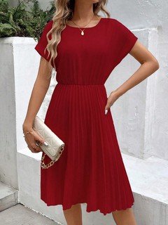 Angled front view of the red short-sleeve pleated midi dress, showing its silhouette and design details.