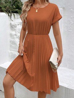 Angled front view of the rust short-sleeve pleated midi dress, showing its silhouette and design details.