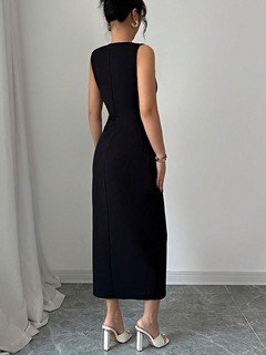 Back view of the black bow-trim side-slit midi dress, showing its silhouette and design details.