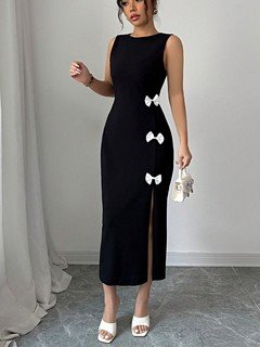 Full-length front view of the black bow-trim side-slit midi dress, showing its silhouette and design details.
