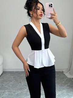 Angled front view of the black and white contrast-trim v-neck peplum top, showing its silhouette and design details.