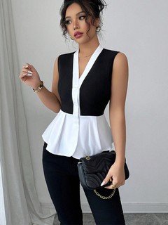 Styled front view of the black and white contrast-trim v-neck peplum top, showing its silhouette and design details.