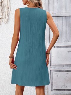 Back view of the teal notch-neck sleeveless shift dress, showing its silhouette and design details.