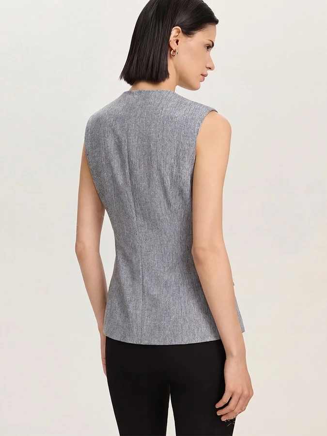 Back view of the gray v-neck asymmetric wrap top, showing its silhouette and design details.