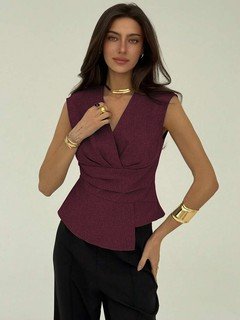Three-quarter front view of the burgundy v-neck asymmetric wrap top, showing its silhouette and design details.