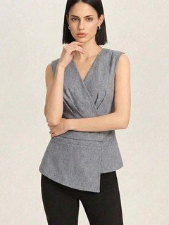 Angled front view of the gray v-neck asymmetric wrap top, showing its silhouette and design details.
