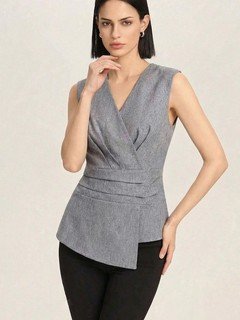 Full-length front view of the gray v-neck asymmetric wrap top, showing its silhouette and design details.
