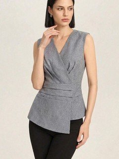 Styled front view of the gray v-neck asymmetric wrap top, showing its silhouette and design details.