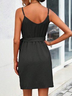 Back view of the black tie-waist faux-wrap mini dress, showing its silhouette and design details.