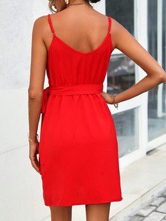 Back view of the red tie-waist faux-wrap mini dress, showing its silhouette and design details.