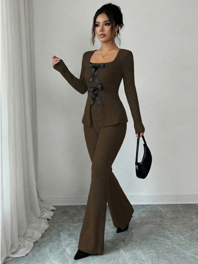 Angled front view of the brown bow-front top and flared pants set, showing its silhouette and design details.