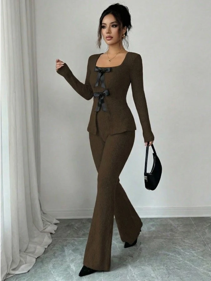 Angled front view of the brown bow-front top and flared pants set, showing its silhouette and design details.