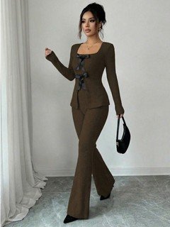 Angled front view of the brown bow-front top and flared pants set, showing its silhouette and design details.