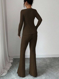 Back view of the brown bow-front top and flared pants set, showing its silhouette and design details.