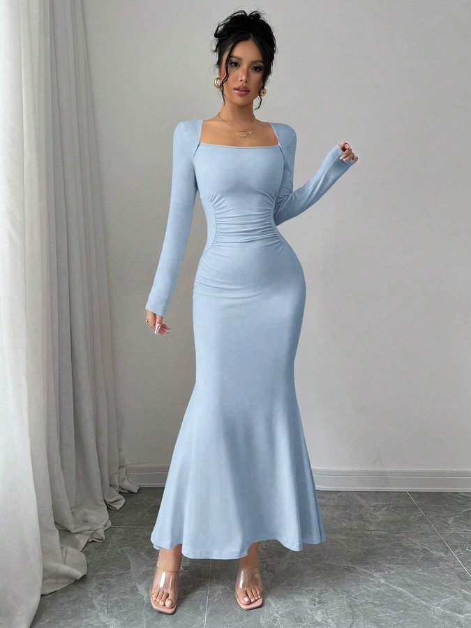 Angled front view of the light blue square-neck fishtail maxi dress, showing its silhouette and design details.