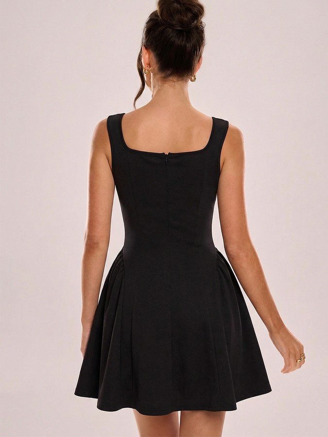 Back view of the black square-neck fit-and-flare dress, showing its silhouette and design details.