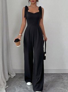 Full length front view of the black square-neck tie-strap wide-leg jumpsuit, showing the silhouette and fit.