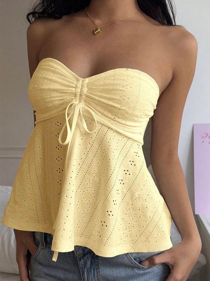 Angled front view of the yellow sweetheart textured peplum top, showing its silhouette and design details.