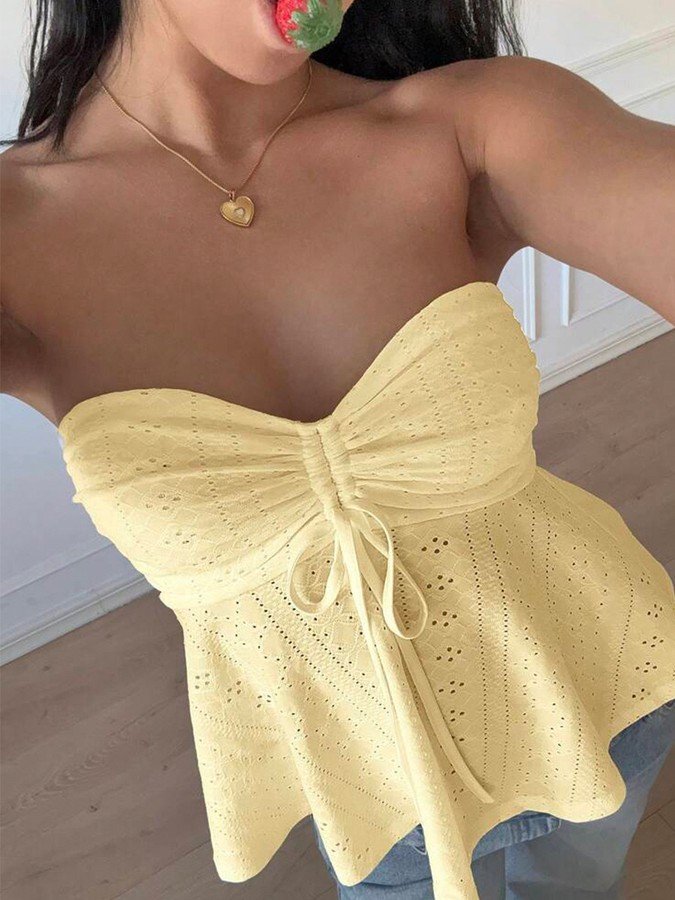 Front view of the yellow sweetheart textured peplum top, showing its silhouette and design details.
