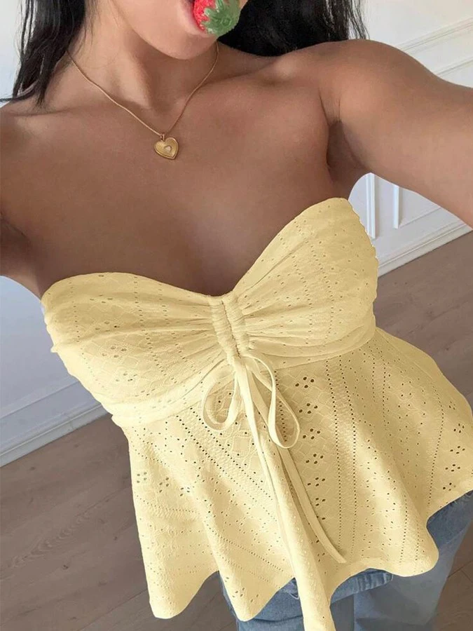 Front view of the yellow sweetheart textured peplum top, showing its silhouette and design details.