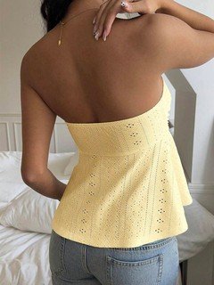 Back view of the yellow sweetheart textured peplum top, showing its silhouette and design details.
