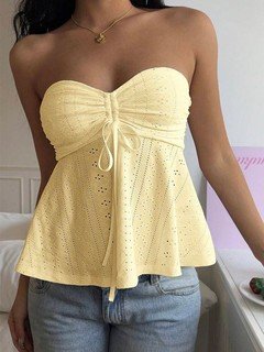 Full-length front view of the yellow sweetheart textured peplum top, showing its silhouette and design details.