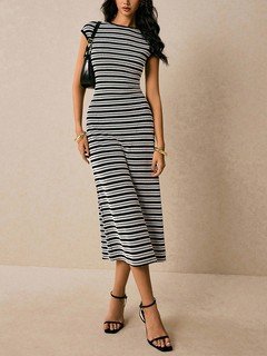 Angled front view of the black and white striped knit bodycon midi dress, showing its silhouette and design details.