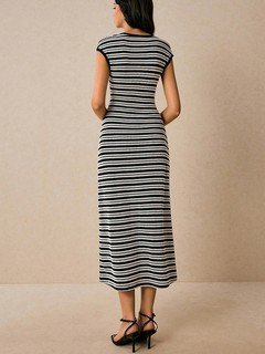 Back view of the black and white striped knit bodycon midi dress, showing its silhouette and design details.