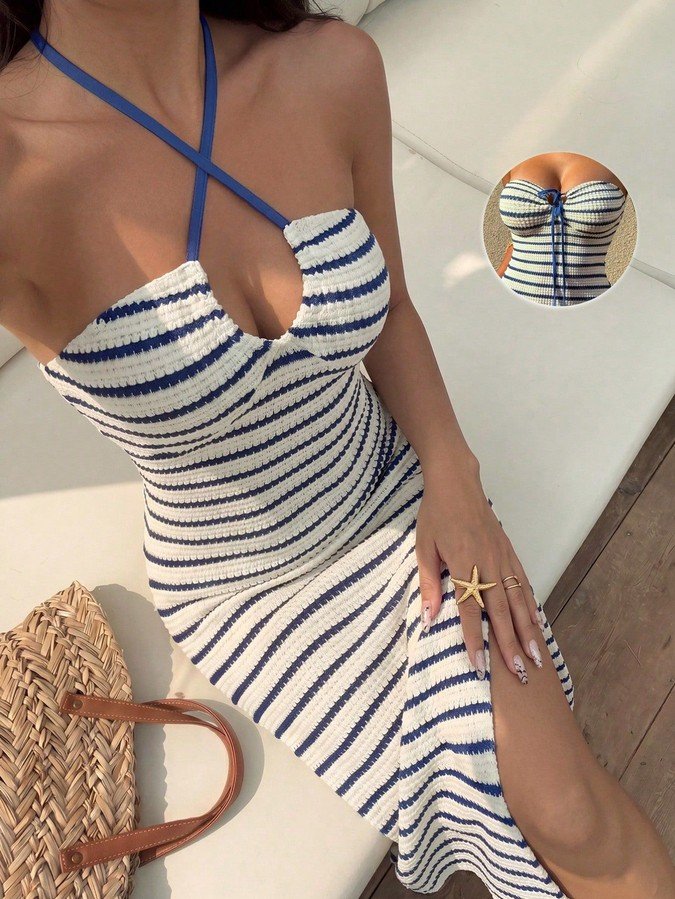 Front close up of the navy striped cross-halter cutout maxi dress, showing cross-halter straps, front cutout and fitted maxi shape.