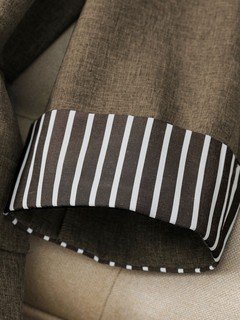 Striped cuff detail of the brown striped-cuff three-quarter-sleeve tailored blazer, showing rolled striped cuffs, notched lapels and tailored fit.