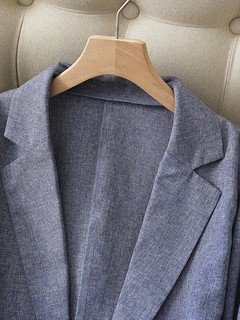 Lapel detail of the gray striped-cuff three-quarter-sleeve tailored blazer, showing rolled striped cuffs, notched lapels and tailored fit.