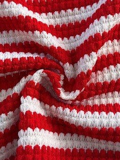 Fabric detail of the red and white striped knit top and shorts set, showing the surface texture and finish.