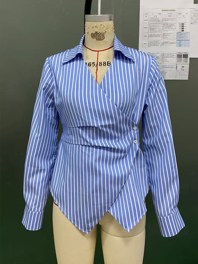 Mannequin view of the blue striped asymmetric wrap shirt, showing the garment shape and construction.