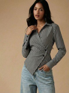 Lifestyle front view of the black and white striped asymmetric wrap shirt, showing its silhouette and design details.