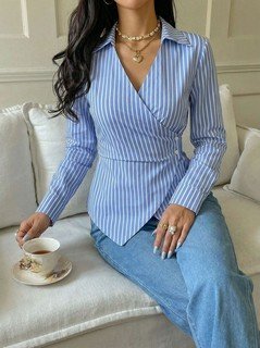 Front fit view of the blue striped asymmetric wrap shirt, showing its silhouette and design details.