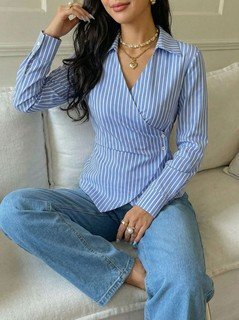 Full-length front view of the blue striped asymmetric wrap shirt, showing its silhouette and design details.