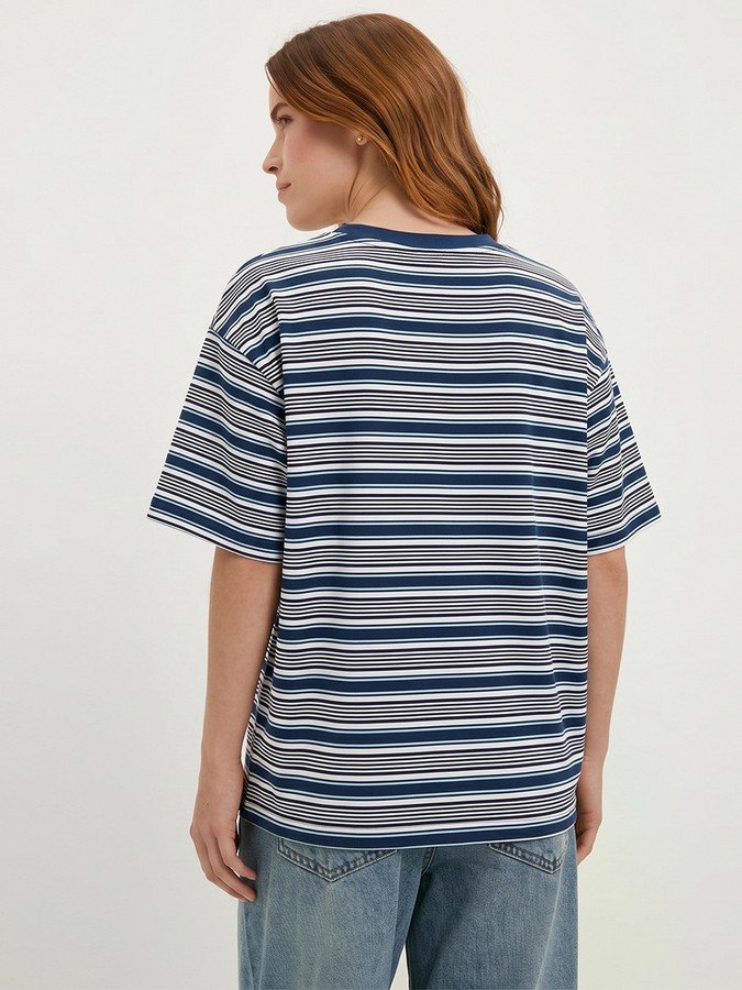 Back view of the blue and gray striped oversized crew-neck tee, showing its silhouette and design details.