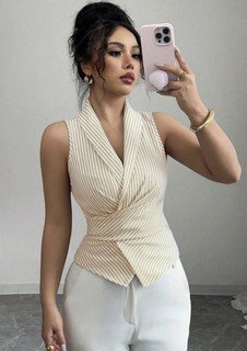 Full-length front view of the cream striped sleeveless wrap blouse, showing its silhouette and design details.