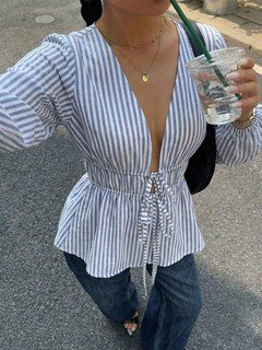 Close-up of the blue and white striped tie-front peplum blouse, showing its silhouette and design details.