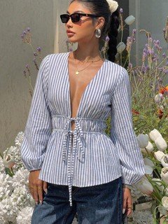 Front view of the blue and white striped tie-front peplum blouse, showing its silhouette and design details.